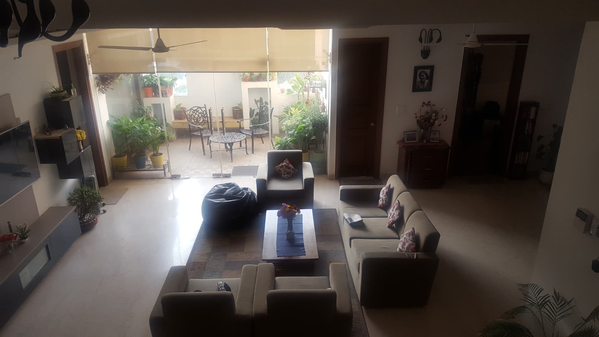Double-height living room seen from the stair, terrace beyond
