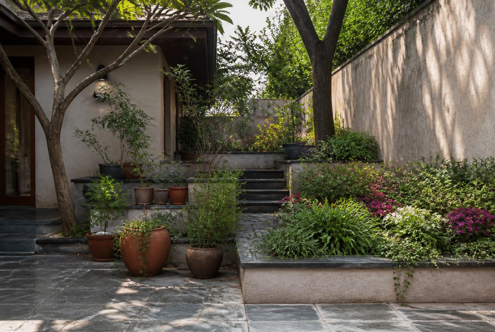 Courtyard garden with tiered pots and flowering beds