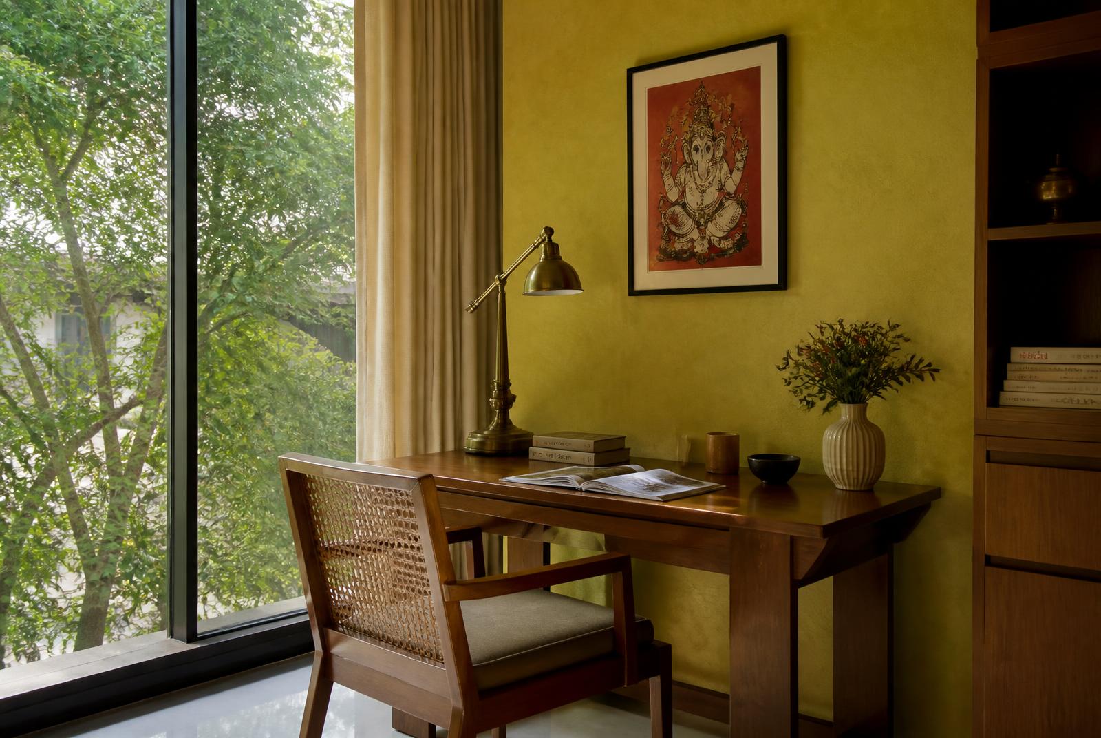 Study desk beside a full-height window in afternoon light